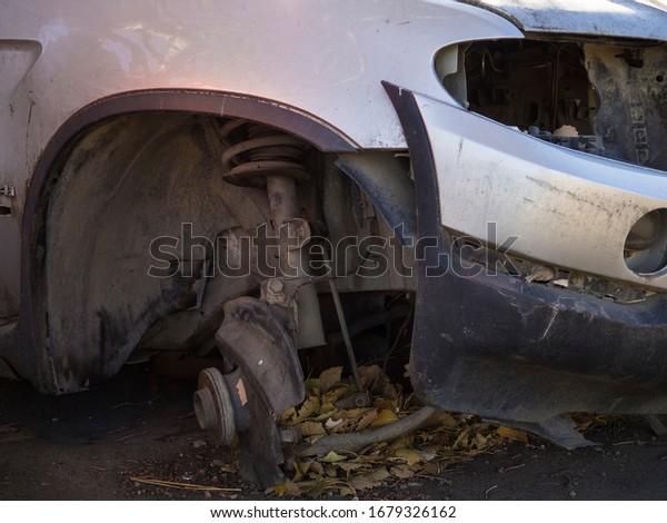 Broken car and removed\
tire