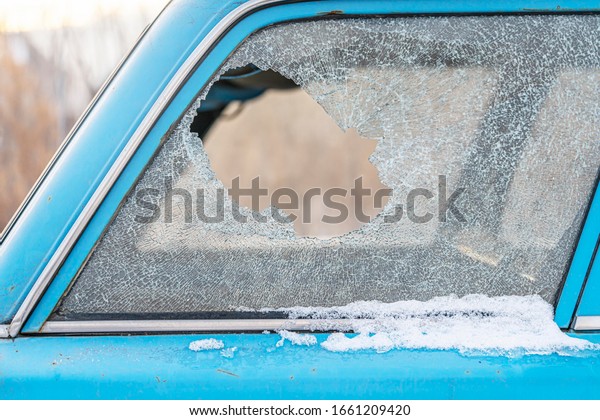 a broken car window, a hole in the\
glass, an insurance claim. Close-up, wagon\
body