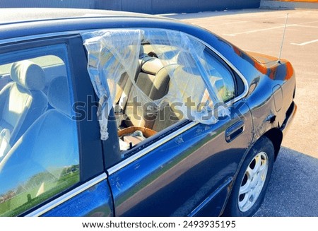 Broken car window. Car robbery. The thief broke the glass in the car window. Vandal broke car window