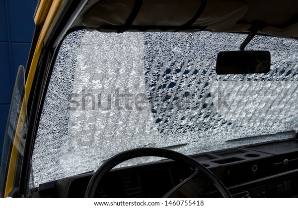broken car window,
windshield after car accident, rockfall. web of splits on an old
windscreen. Accident
concept