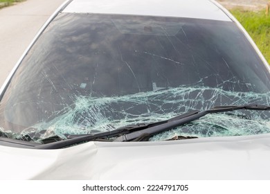 Broken car windshield .Crash windshield glass the broken and damaged car. Tempered glass shattered in an accident. Broken Windshield