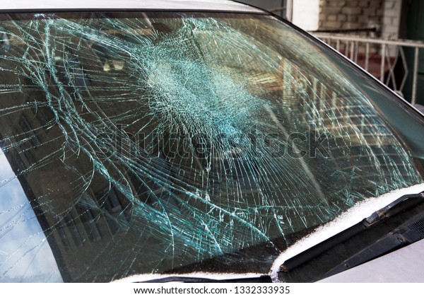 Broken car windshield.\
Broken glass.