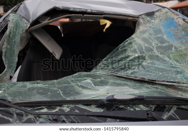 A broken car windshield, in a car graveyard,\
Kozani, Greece.