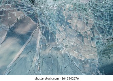 Broken Car Windshield With Sky Reflection. Close Up