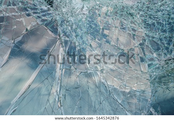 broken car\
windshield with sky reflection. close\
up