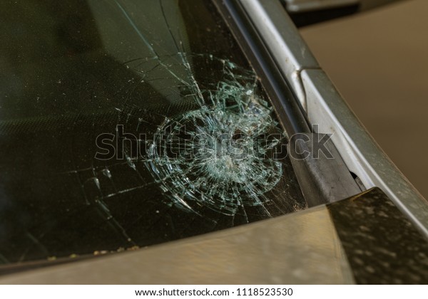 Broken car\
windshield. Stones on a dirty road from under the wheels at a speed\
smash car glass. Criminal incidents. Vandals, hooligans mutilated\
the car, smashed the\
windshield