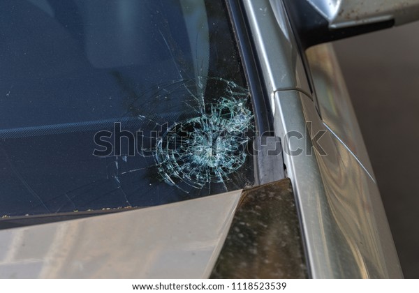 Broken car\
windshield. Stones on a dirty road from under the wheels at a speed\
smash car glass. Criminal incidents. Vandals, hooligans mutilated\
the car, smashed the\
windshield