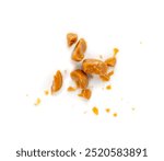 Broken caramel candies isolated, toffee caramel crumbs, round hard milk confectionery pieces, brown sugar candies, small caramel sweets on white background