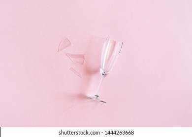 Broken Champagne Flute With Splinters On Pink Background With Copy Space. Concept Fight Against Alcoholism, Drunkenness And Refusal Of Alcohol. Creative Top View Flat Lay.