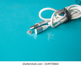 The Broken Charger Cable On Blue Background