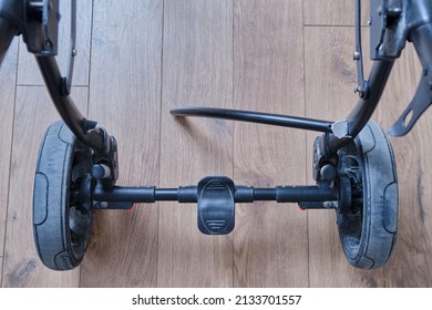 Broken Chassis Of A Baby Stroller, Damage To The Crossbar Of The Metal Frame Of The Pram