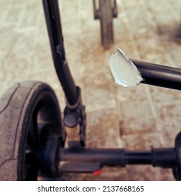 Broken Chassis Of A Baby Stroller, Damage To The Crossbar Of The Metal Frame Of The Pram