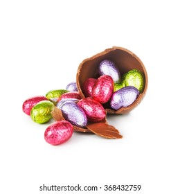 Broken Chocolate Easter Egg Wrapped In Pink Foil With Colorful Candies Isolated On White Background