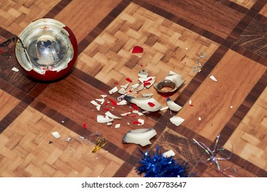 Broken Christmas Decoration And Shards Lie On The Floor