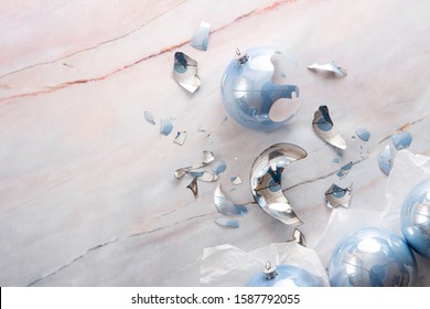 Broken Christmas Light Blue Ball On A Marble Floor. Light Blue Balls