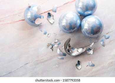 Broken Christmas Light Blue Ball On A Marble Floor. Light Blue Balls