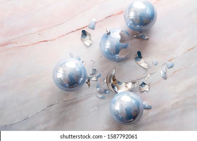 Broken Christmas Light Blue Ball On A Marble Floor. Light Blue Balls