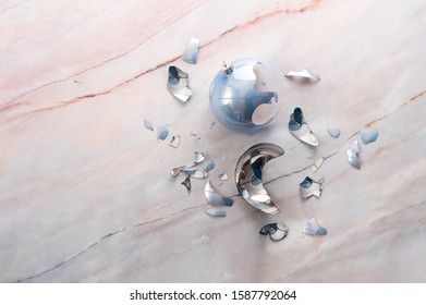 Broken Christmas Light Blue Ball On A Marble Floor. Free Place