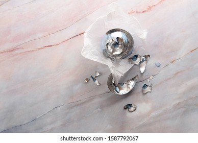 Broken Christmas Light Blue Ball On A Marble Floor. Free Place