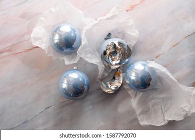 Broken Christmas Light Blue Ball On A Marble Floor. Light Blue Balls