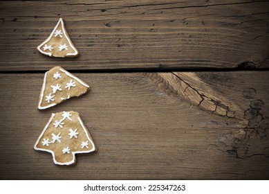 Broken Christmas Tree Cookie On Wooden Background With Copy Space With Frame