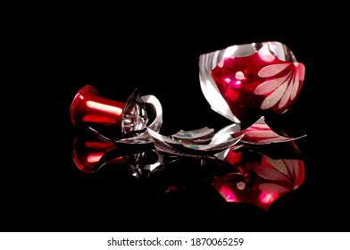 Broken Christmas Tree Decoration Ball Isolated On The Black Reflective Background