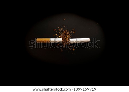 Broken cigarette on a black table