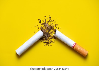 
Broken Cigarette And The Tobacco Leaves Inside On Yellow Back Ground. Quite Smoking Concept.