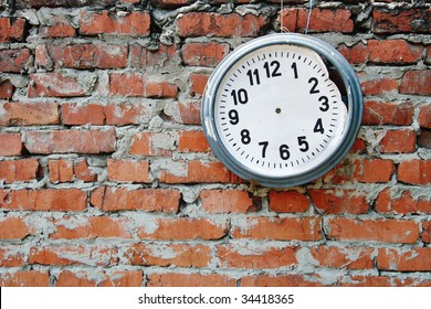 Broken Clock On The Brick Wall.