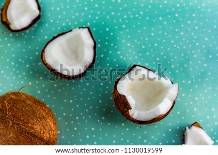 Broken coconut on aqua background.Selective focus.