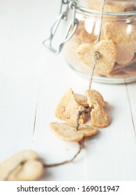 Broken Cookie On Cord From Jar On Wooden Table, Selective Focus