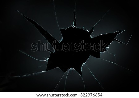 broken cracked glass with big hole over black background Foto d'archivio © 