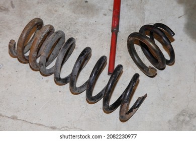 Broken Cracked Old Car Coil Spring Parts On Concrete Floor