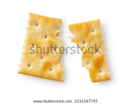 Broken crackers placed on a white background. Viewed from above.