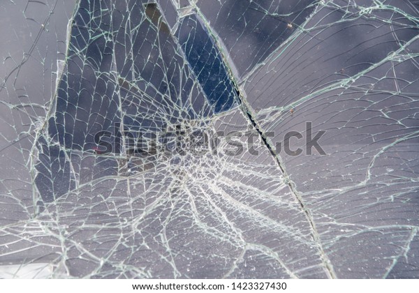 Broken in the cracks of the windshield of the\
car, after a car\
accident.