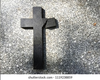 A Broken Cross On A Grave Of A Cemetery