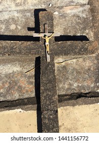 Broken Crucifix On Cement Cross On Slab In Cemetery