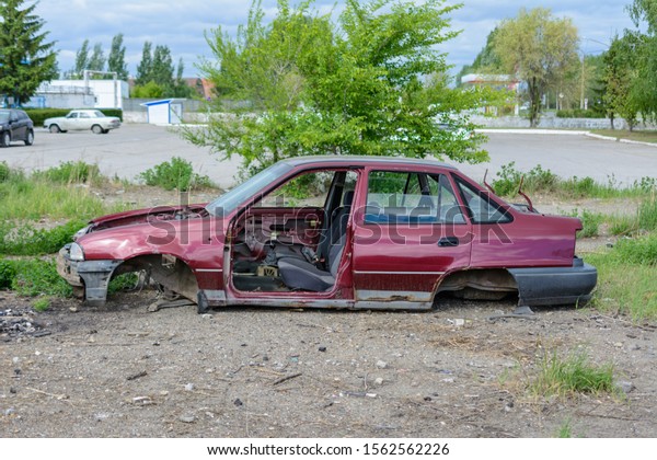Broken, crumpled, dented car after the\
accident. Abandoned wrecked cars. Dump of wrecked cars. Broken auto\
after an accident.