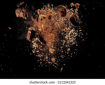Broken and crushed cookies explosion on black background