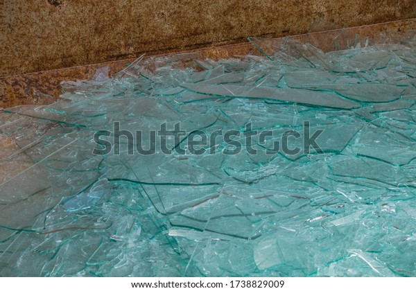 Broken and damaged glass panes in the\
recyclables container