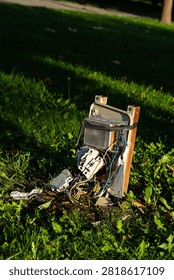 Broken and damaged outdoor electrical control box on grass