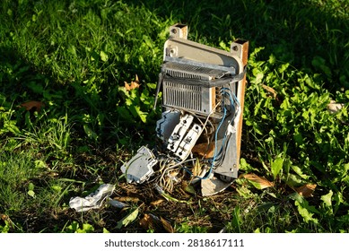 Broken and damaged outdoor electrical control box on grass