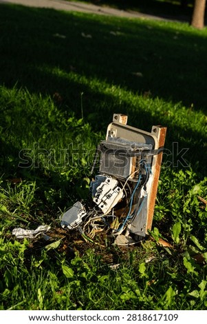 Broken and damaged outdoor electrical control box on grass