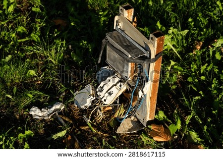 Broken and damaged outdoor electrical control box on grass
