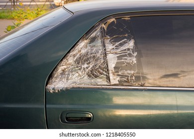 Broken Dark Car Rear Window Sealed With Scotch Tape