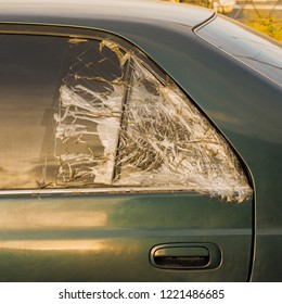 Broken Dark Car Rear Window Sealed With Scotch Tape