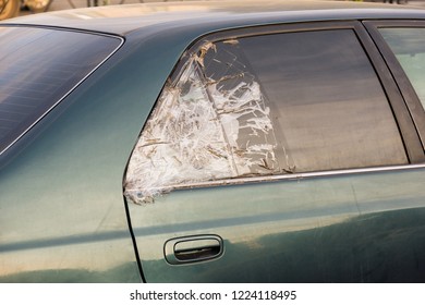 Broken Dark Car Rear Window Sealed With Scotch Tape