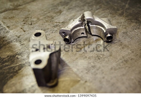 Broken\
dirty parts from the engine crankshaft, two\
halves