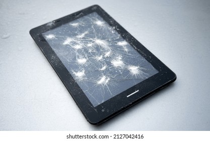 A Broken Display On An Electronic Tablet, Cracks On The Screen. Repair Of Cellular Equipment.