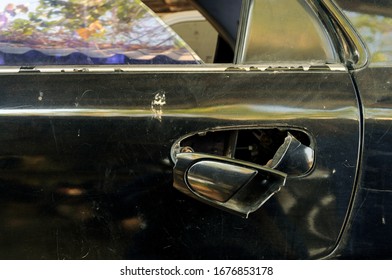 Broken Door Handle Of A Black Car In The Garage.